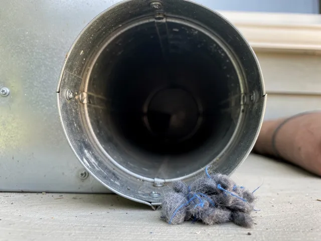 Coventry Dryer Vent Cleaning technician using specialized equipment to clear severe dryer vent blockage in Coventry